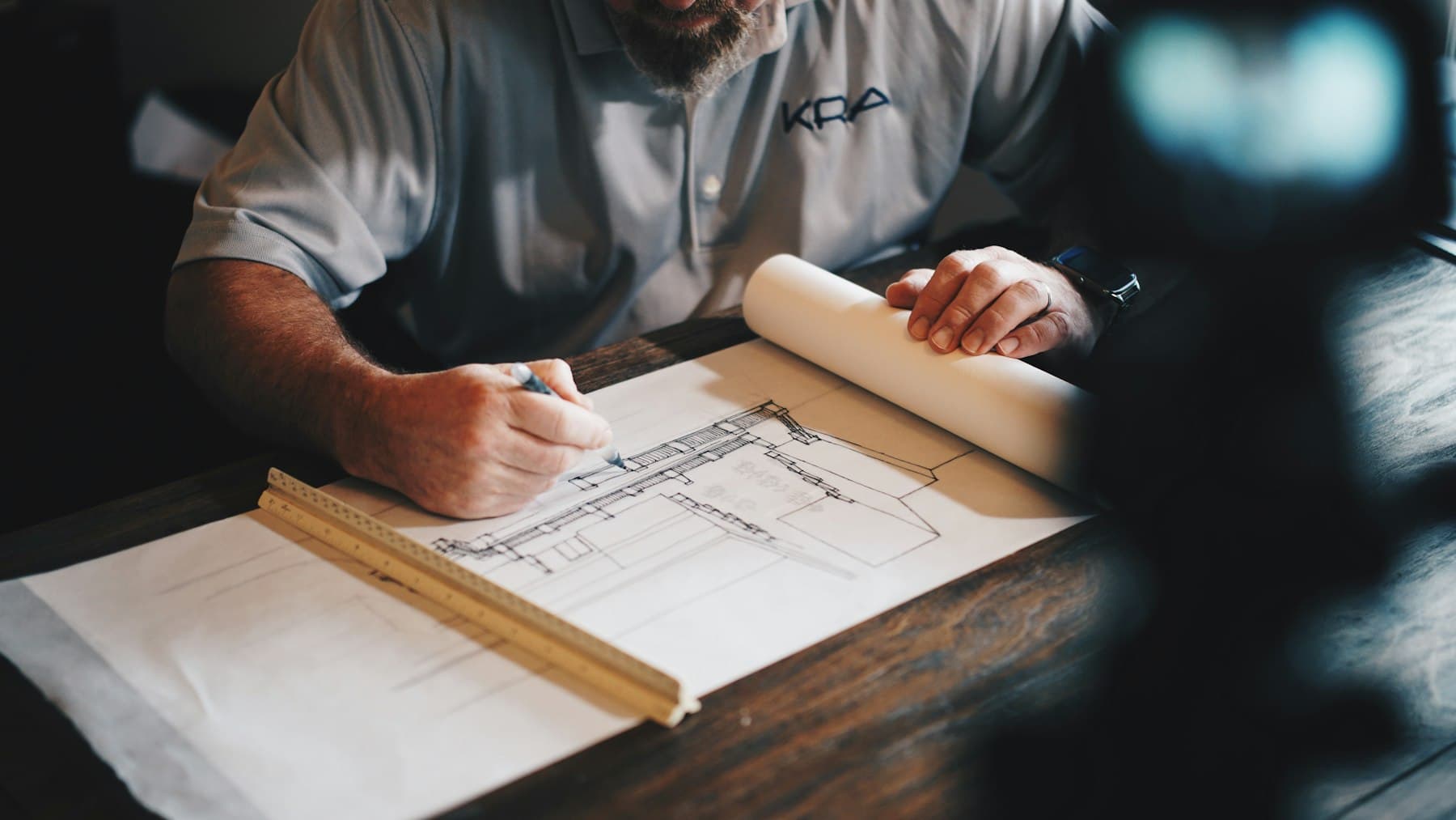 Architect marking a floor plan on the drawing table
