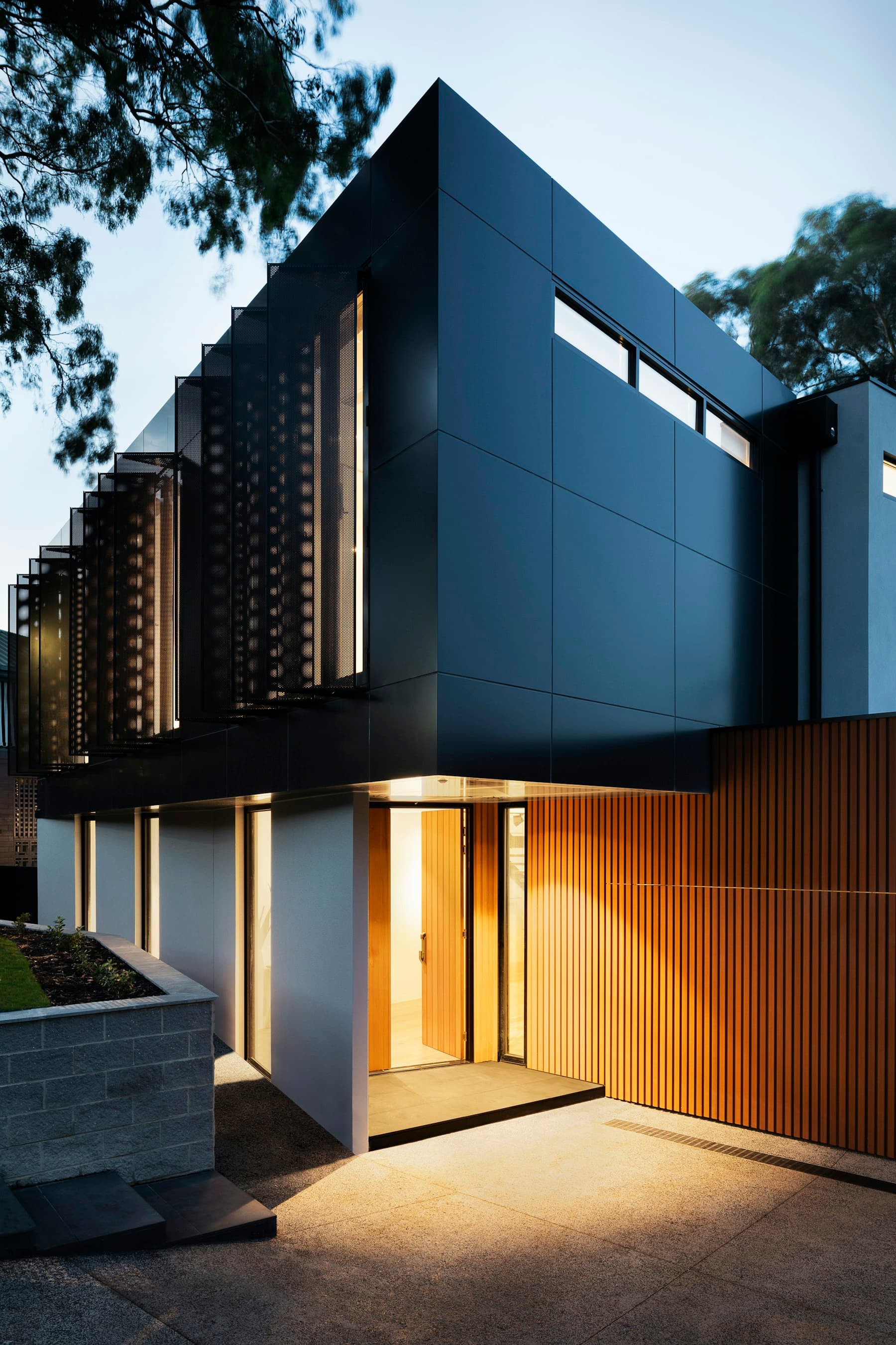 Night entry walkthrough — timber and metal façade