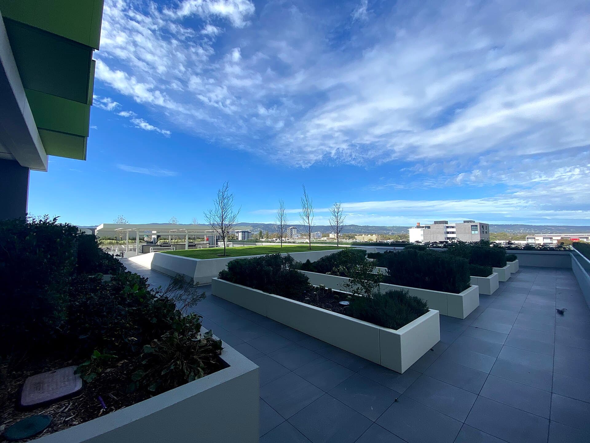Apartment podium sky garden with planters and lawn