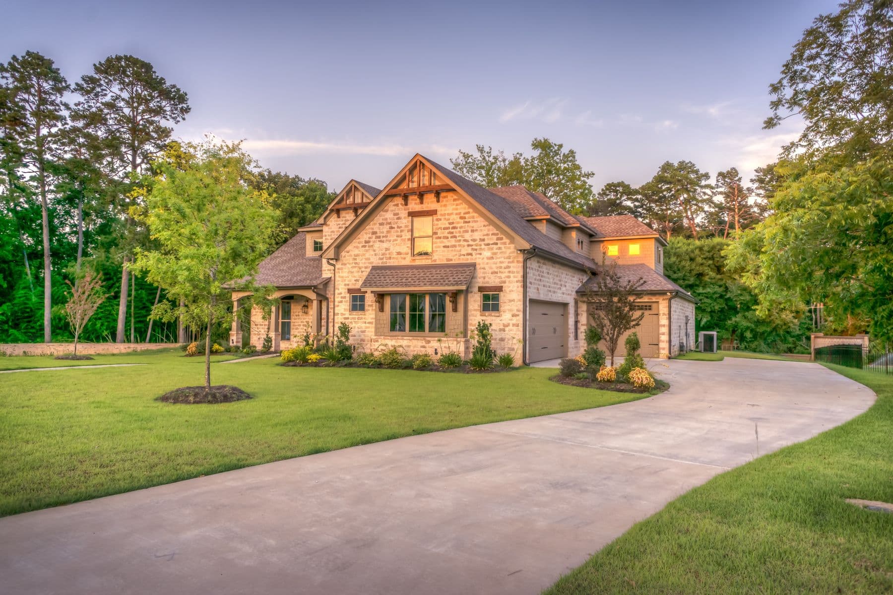 Residence with curved drive, lawn, and foundation planting