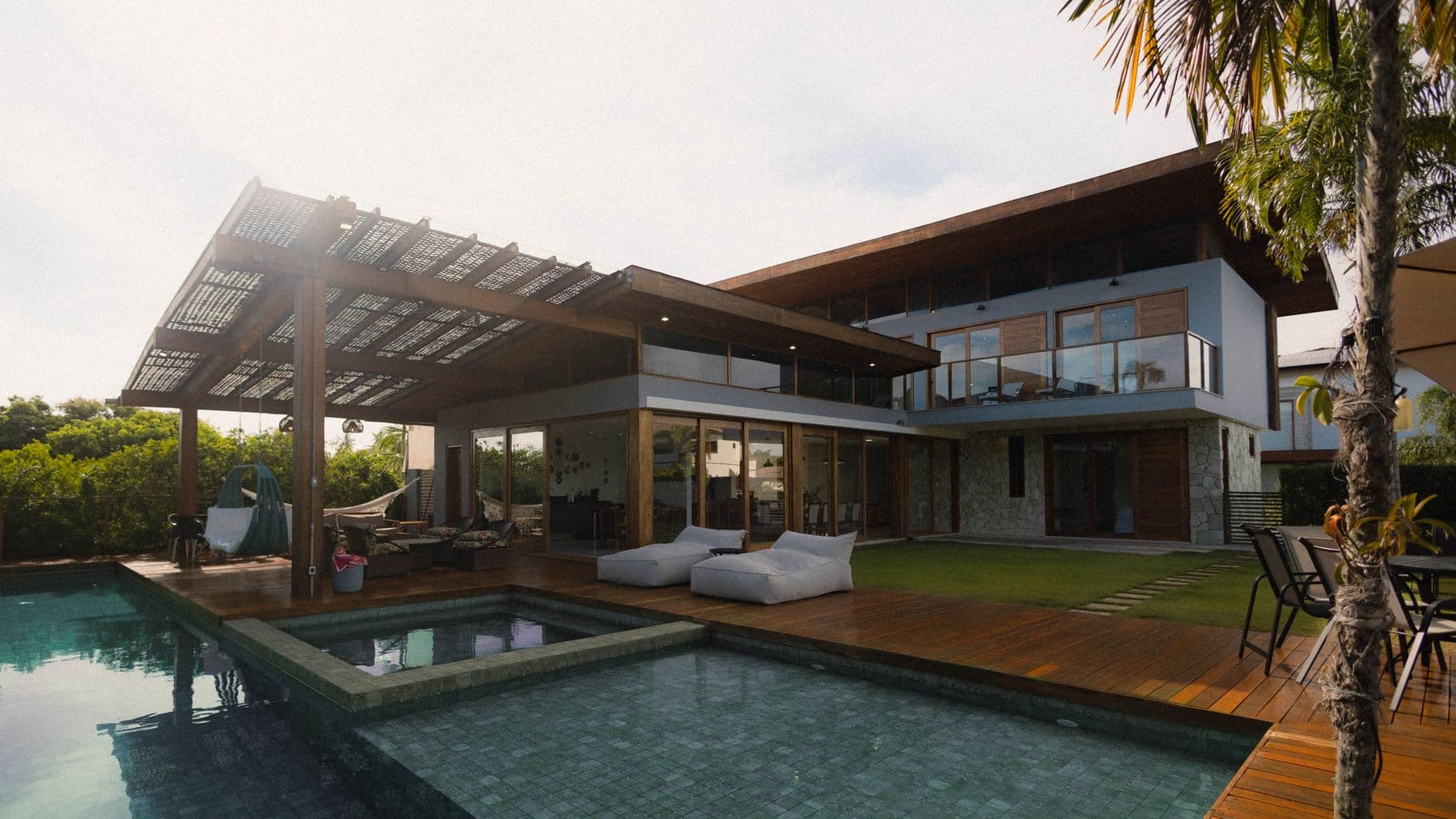 Villa pool deck, pergola, and lawn